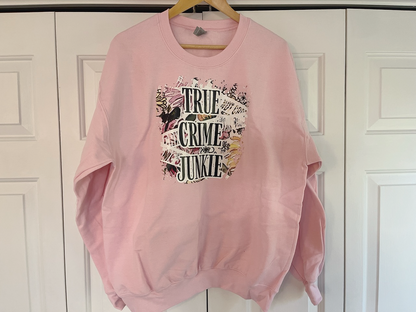 a pink sweatshirt hanging on a white door