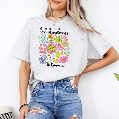 a woman wearing a t - shirt that says let kindness bloom