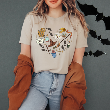 A woman wearing a t-shirt with a graphic design of various objects and symbols, including bats, a hat, and a bird, standing against a dark background.