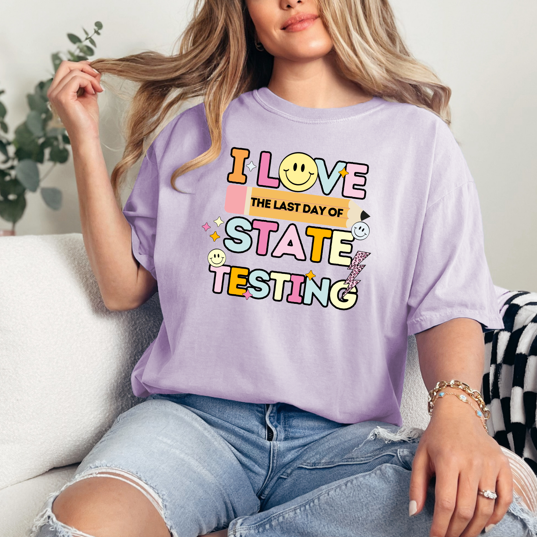a woman sitting on a couch wearing a t - shirt that says i love the