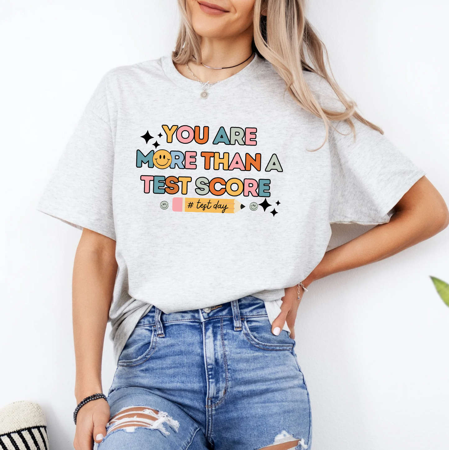 a woman wearing a t - shirt that says you are more than a test score