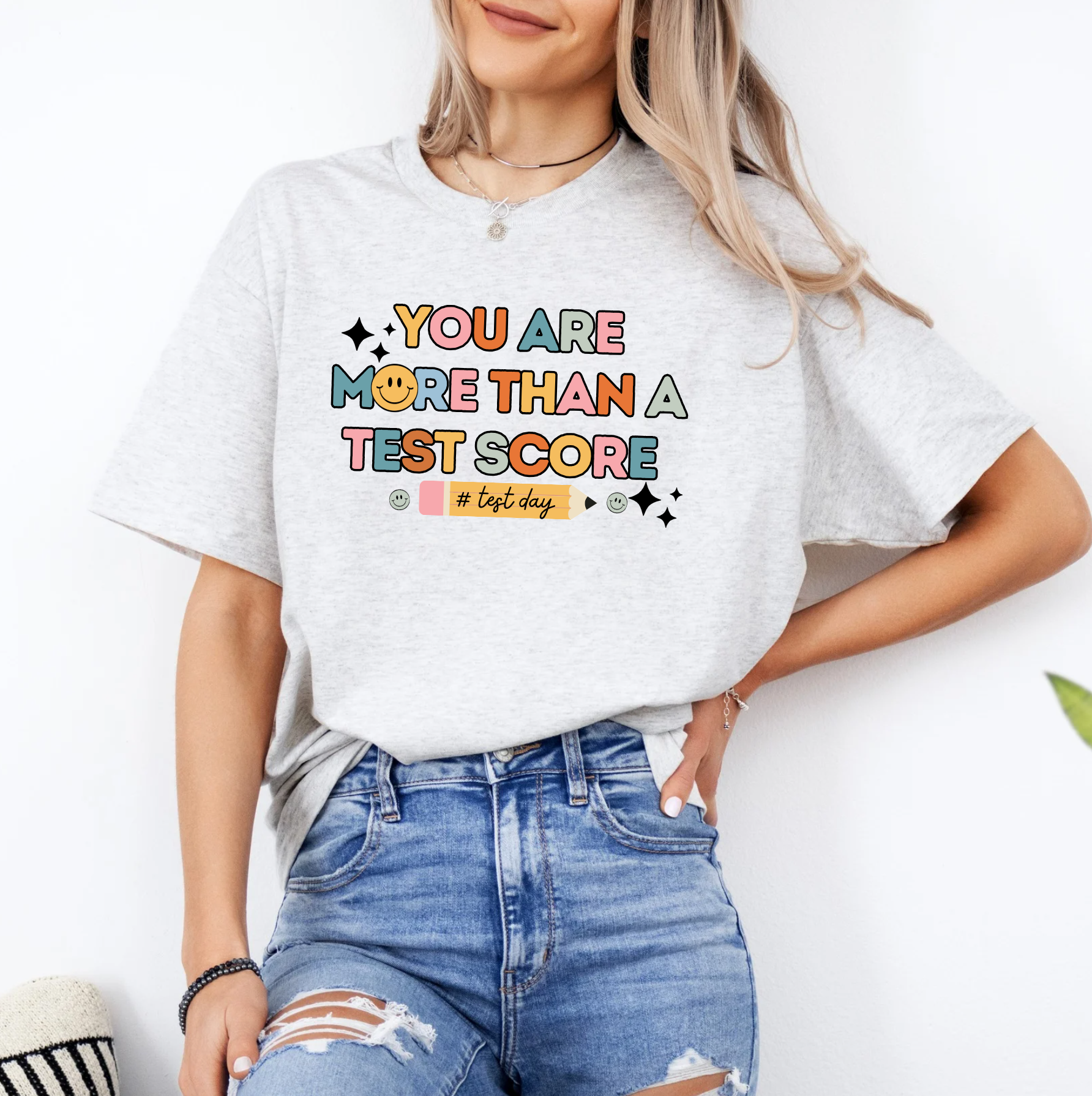 a woman wearing a t - shirt that says you are more than a test score
